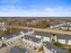 Aerial view of a residential community featuring townhomes, tree-lined streets, and well-maintained landscaping at 6464 Park Pond Dr # 7, Charlotte, NC 28262
