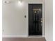 Black front door with gold hardware, peephole, and the number 6464 above the door at 6464 Park Pond Dr # 7, Charlotte, NC 28262