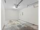 Attached garage featuring a neutral painted interior, overhead lighting, and a door to the interior at 6464 Park Pond Dr # 7, Charlotte, NC 28262