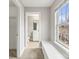 The hallway contains a window seat and provides a pass through to the bathroom at 6464 Park Pond Dr # 7, Charlotte, NC 28262