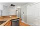Kitchen area with light wood cabinets, granite countertops, and stainless steel dishwasher at 6464 Park Pond Dr # 7, Charlotte, NC 28262