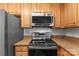 Close up of stainless steel appliances, granite countertops, and white subway tile backsplash at 6464 Park Pond Dr # 7, Charlotte, NC 28262