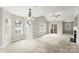 Spacious living room with a fan, natural light, carpet, and a sliding glass door to a balcony at 6464 Park Pond Dr # 7, Charlotte, NC 28262