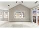 Open living space featuring a sliding door and a vaulted ceiling at 6464 Park Pond Dr # 7, Charlotte, NC 28262