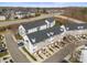 Aerial view of townhomes with neutral exteriors, dark roofs, individual driveways, and manicured lawns at 6464 Park Pond Dr # 7, Charlotte, NC 28262
