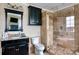 Well-lit bathroom featuring a glass-enclosed shower, vanity, and a large mirror at 649 46Th Avenue Ne Dr, Hickory, NC 28601