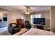 Spacious bedroom featuring a ceiling fan and a large flat-screen television for comfortable viewing at 649 46Th Avenue Ne Dr, Hickory, NC 28601