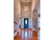 Grand entryway featuring hardwood floors, a stylish light fixture, and a blue front door at 649 46Th Avenue Ne Dr, Hickory, NC 28601