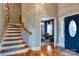 Bright foyer featuring hardwood floors, a staircase, and a view into the living space at 649 46Th Avenue Ne Dr, Hickory, NC 28601