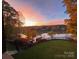 Beautiful sunset over the lake, trees in fall colors, green grass, and black aluminum fence at 649 46Th Avenue Ne Dr, Hickory, NC 28601