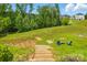 Expansive backyard with a firepit area and stairs to the home at 6858 Hunts Mesa Dr, Fort Mill, SC 29707