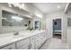 This bright bathroom features a double vanity, a large mirror, and marble tile flooring at 6858 Hunts Mesa Dr, Fort Mill, SC 29707