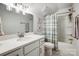 Bright bathroom features a vanity with a mirror, shower with curtain and a toilet at 6858 Hunts Mesa Dr, Fort Mill, SC 29707