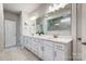 Elegant bathroom features a double vanity, large mirror, and a walk-in shower with beautiful marble tiling at 6858 Hunts Mesa Dr, Fort Mill, SC 29707