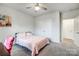 Bedroom featuring a bed with pink covers, a ceiling fan, and neutral walls at 6858 Hunts Mesa Dr, Fort Mill, SC 29707
