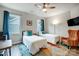 Cozy bedroom featuring two twin beds, bright windows, and a colorful rug at 6858 Hunts Mesa Dr, Fort Mill, SC 29707