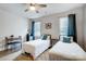 This bedroom features two twin beds, bright windows, and a ceiling fan at 6858 Hunts Mesa Dr, Fort Mill, SC 29707