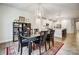 Open-concept dining area with a view into the modern kitchen and a decorative rug adding warmth and style at 6858 Hunts Mesa Dr, Fort Mill, SC 29707