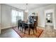 Bright dining area features a large window and elegant decor, flowing into other living spaces for easy entertaining at 6858 Hunts Mesa Dr, Fort Mill, SC 29707