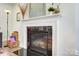 Close-up view of a modern fireplace with decorative mantel and a glimpse of comfortable seating at 6858 Hunts Mesa Dr, Fort Mill, SC 29707