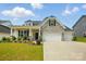 Charming home with stone accents, inviting curb appeal, and a two car garage at 6858 Hunts Mesa Dr, Fort Mill, SC 29707