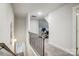 Upstairs hallway boasts neutral colors and a carpeted floor, leading to a room with gym equipment at 6858 Hunts Mesa Dr, Fort Mill, SC 29707
