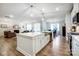 Spacious kitchen with a large island, stainless steel appliances, and an open floor plan to living and dining areas at 6858 Hunts Mesa Dr, Fort Mill, SC 29707