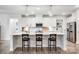 Modern kitchen featuring a large island with barstool seating, stainless steel appliances, and stylish pendant lighting at 6858 Hunts Mesa Dr, Fort Mill, SC 29707