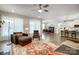 Spacious open-concept living area featuring large windows, a dining area, and a glimpse of the modern kitchen at 6858 Hunts Mesa Dr, Fort Mill, SC 29707