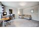 Spacious living room featuring neutral tones, carpet floors, desk, and comfortable seating area at 6858 Hunts Mesa Dr, Fort Mill, SC 29707