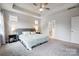 Spacious main bedroom featuring a tray ceiling, large windows, and plush carpet for a cozy and inviting atmosphere at 6858 Hunts Mesa Dr, Fort Mill, SC 29707