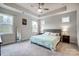 Relaxing main bedroom with a tray ceiling, plush carpet, and abundant natural light from multiple windows at 6858 Hunts Mesa Dr, Fort Mill, SC 29707