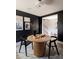 Contemporary dining area featuring black walls, modern artwork, and a unique table at 7003 Impulse Ct, Charlotte, NC 28205