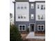 Stylish new construction townhome with a mix of gray siding, complemented by neatly landscaped grounds at 7003 Impulse Ct, Charlotte, NC 28205