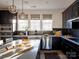 Well-equipped kitchen with dark cabinetry, stainless steel appliances, and a center island at 7003 Impulse Ct, Charlotte, NC 28205
