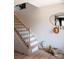 Inviting staircase with wooden treads and stylish black railings, accented by charming decor and a natural wood floor at 7003 Impulse Ct, Charlotte, NC 28205