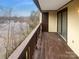 Enjoy stunning water views from the private balcony with wood decking and a dark wood railing at 8069 Cedar Glen Dr, Charlotte, NC 28212