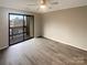 Spacious bedroom boasting natural light, sliding glass door to a large balcony, and hardwood floors at 8069 Cedar Glen Dr, Charlotte, NC 28212
