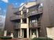A multi-level condo building with wood siding and private balconies offers a unique and inviting living space at 8069 Cedar Glen Dr, Charlotte, NC 28212