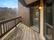 Charming home entrance with a wooden porch, outdoor lighting, and views of the surrounding greenery at 8069 Cedar Glen Dr, Charlotte, NC 28212