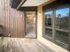 Welcoming home entrance with a wooden porch, outdoor lighting, and views of the surrounding greenery at 8069 Cedar Glen Dr, Charlotte, NC 28212