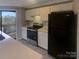Well-lit kitchen featuring white cabinets, modern appliances, and a countertop, ready for culinary creations at 8069 Cedar Glen Dr, Charlotte, NC 28212