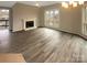 An airy living room with hardwood floors, a fireplace, and a large window, creating a comfortable and inviting atmosphere at 8069 Cedar Glen Dr, Charlotte, NC 28212