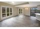Bright living area with large windows, hardwood floors, and a sliding glass door to a private deck, ideal for entertaining at 8069 Cedar Glen Dr, Charlotte, NC 28212