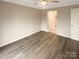 A calm bedroom showcasing hardwood floors, a neutral color scheme, and an ensuite bathroom at 8069 Cedar Glen Dr, Charlotte, NC 28212