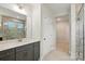 Modern bathroom features a gray vanity, quartz countertop, and a glass-enclosed shower at 8716 Acadia Pkwy # 596, Sherrills Ford, NC 28673