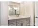 Bathroom with gray cabinets, quartz countertops, and a large mirror reflecting the tiled shower at 8716 Acadia Pkwy # 596, Sherrills Ford, NC 28673