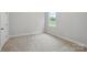 Bright bedroom featuring neutral carpet, one window, and a view of nature at 8716 Acadia Pkwy # 596, Sherrills Ford, NC 28673
