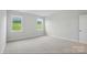 Bright carpeted bedroom with two large windows offering outdoor views at 8716 Acadia Pkwy # 596, Sherrills Ford, NC 28673