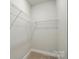Uncluttered walk-in closet featuring white wire shelving and neutral carpeting at 8716 Acadia Pkwy # 596, Sherrills Ford, NC 28673